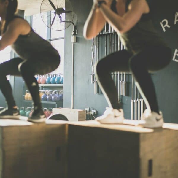 women on jumping boxes