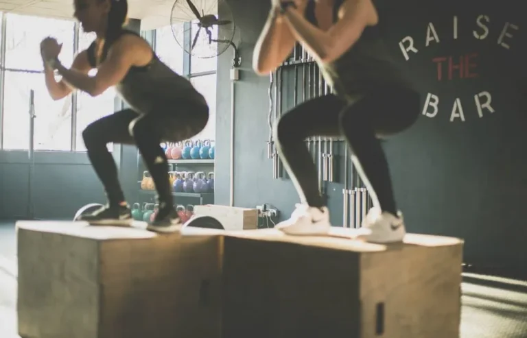 women on jumping boxes