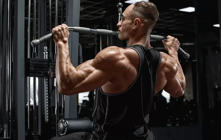 Muscular man workout in gym, doing exercise for back, lat pulldown