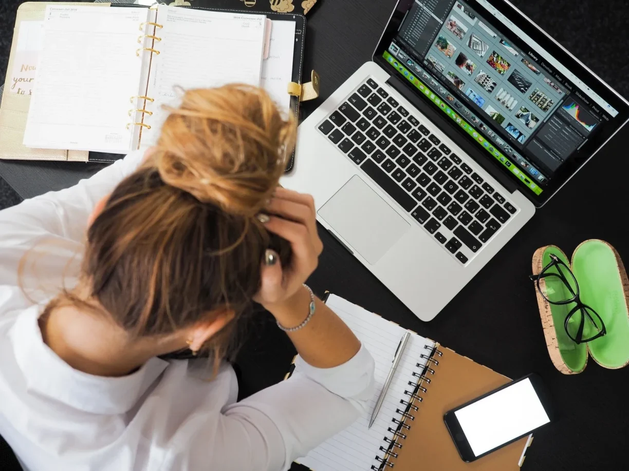 woman looks tired at desk