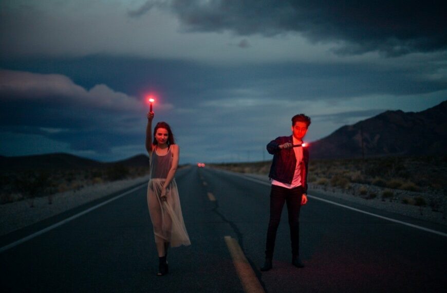 couple in road with firelights