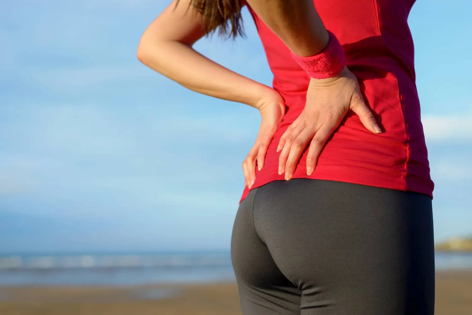 person holding their back