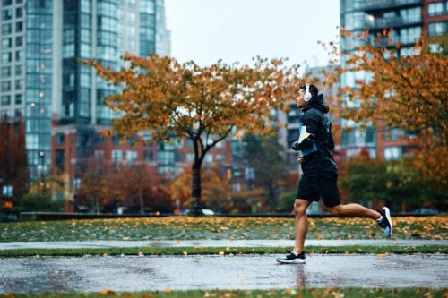 Motivated male athlete running in rain