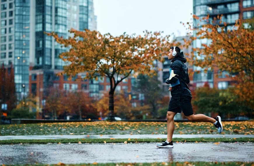 Motivated male athlete running in rain