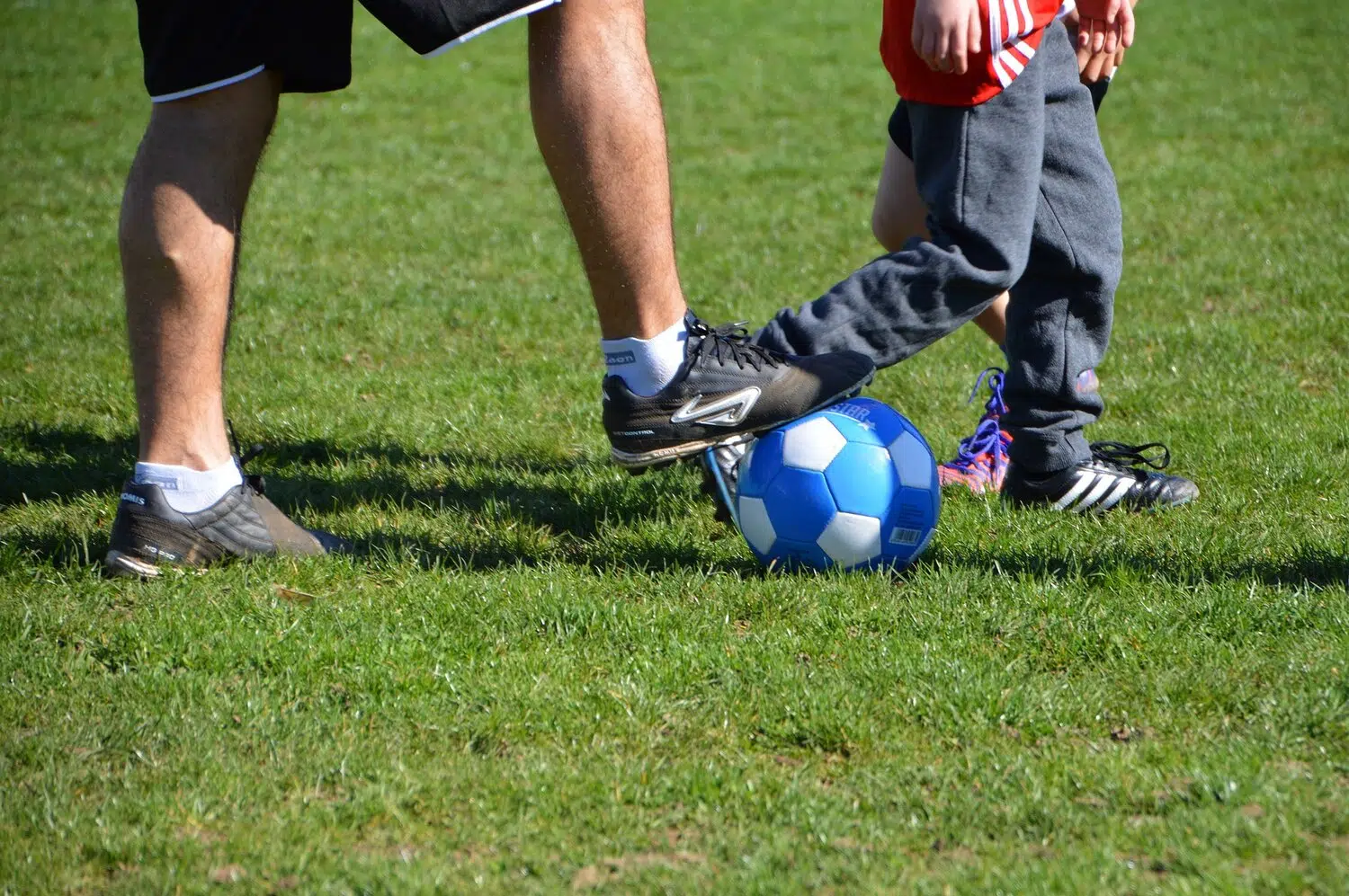 Man and child playing football