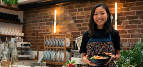 woman holding bowl of food e1673796968557