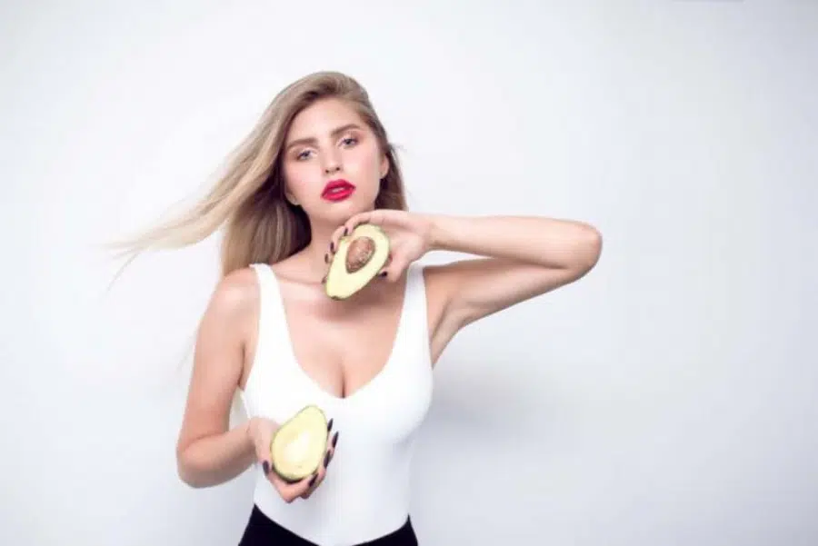 Woman holds avocados