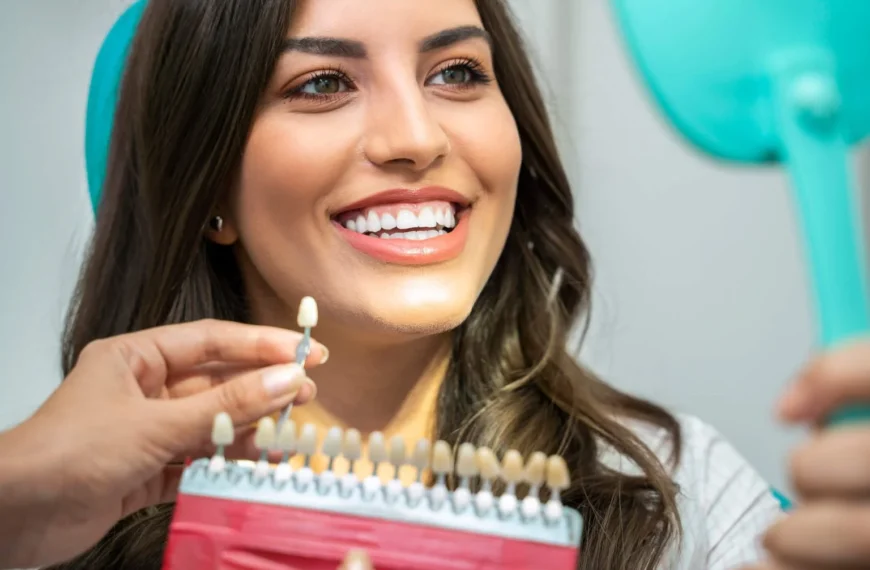 Woman compares teeth shades with dentist