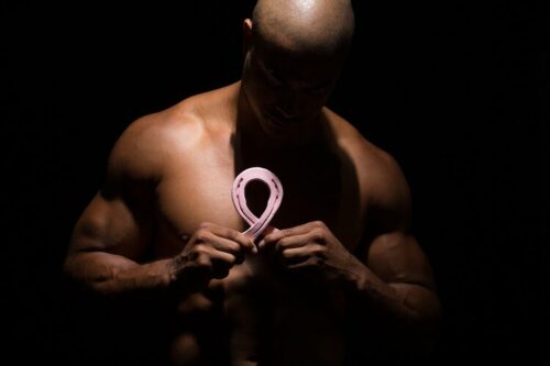 male model with pink cancer ribbon