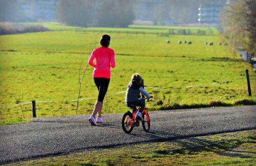 mum running with child on bike