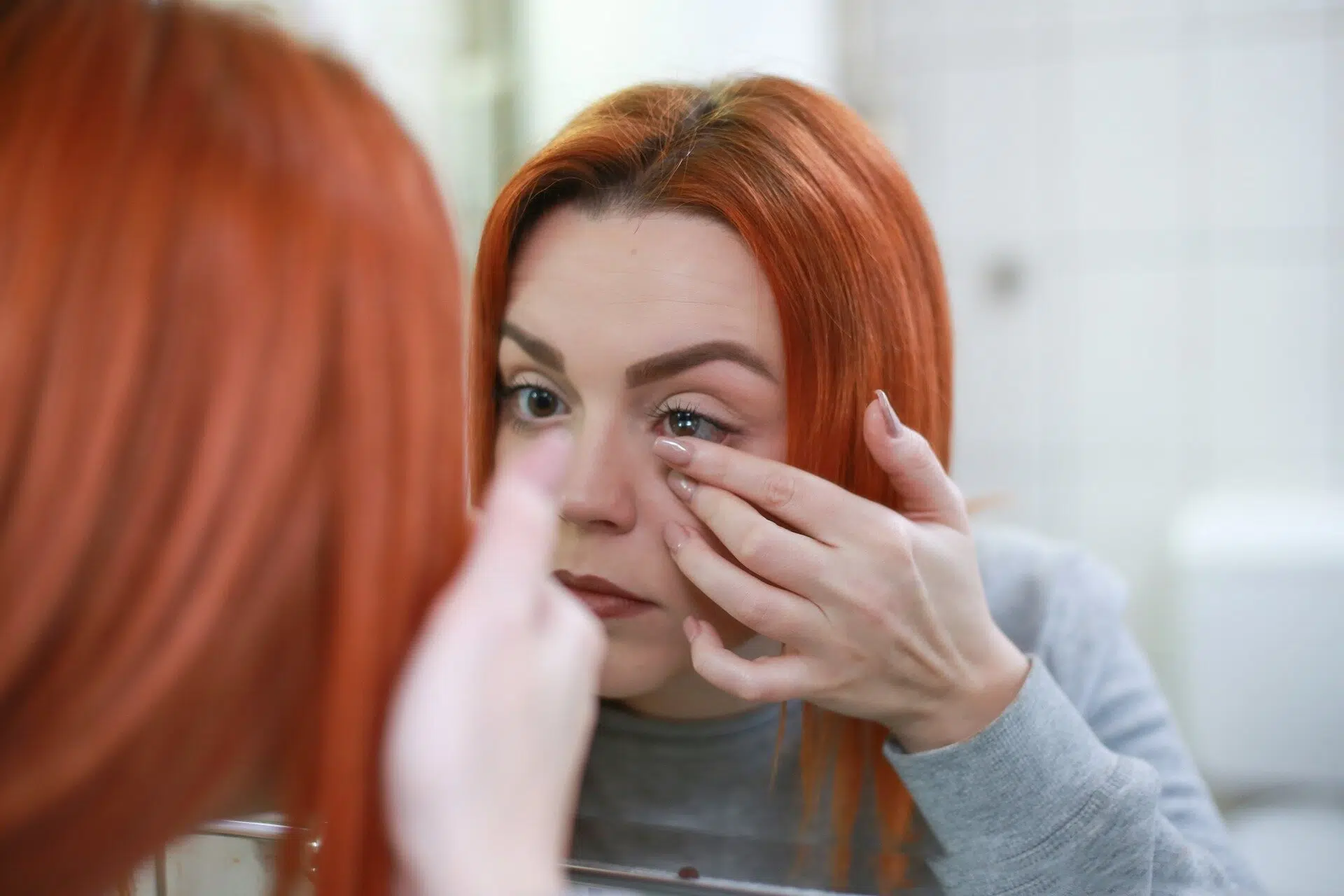 Woman putting contact lenses in eye