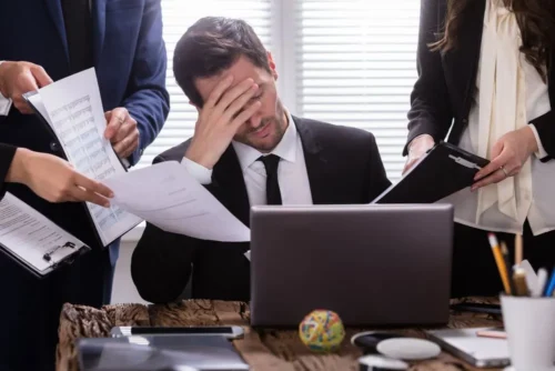 man looks stressed at work