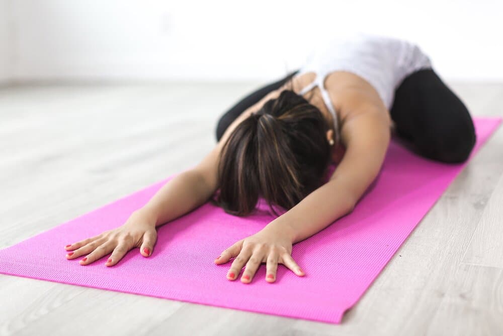 Woman face down on yoga mat