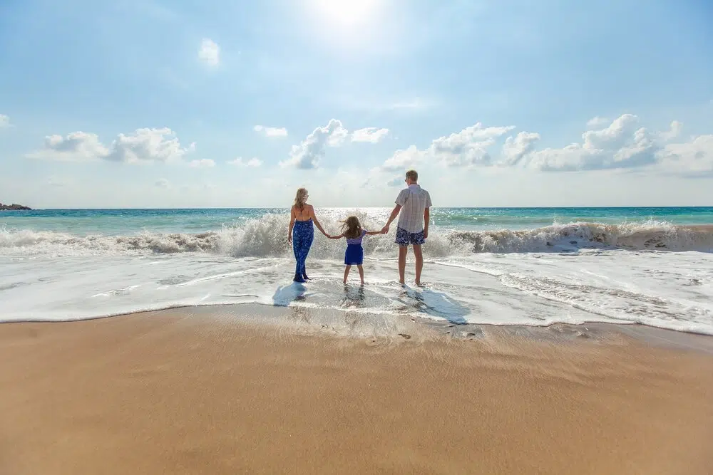 Family walk along the beach
