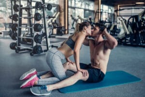 couple kissing in the gym