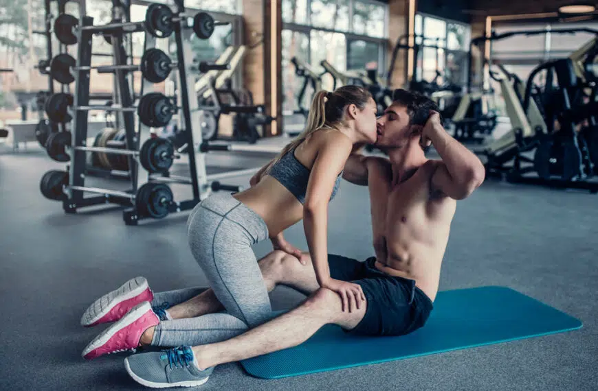 couple kissing in the gym