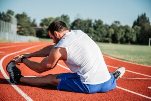 manstretchingonathletictrack