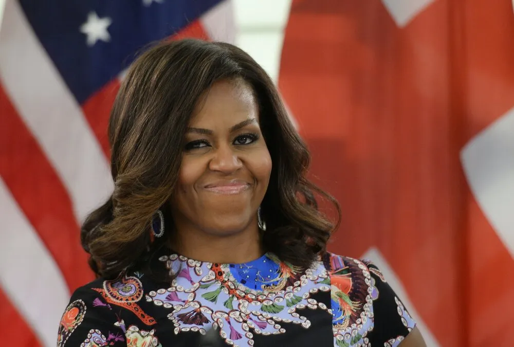 michelle obama in front of stars and stripes flag