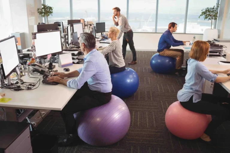 office workers sitting on gym ball
