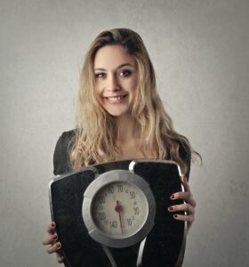 woman in black shirt holding black and silver weight scale 3775540