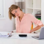 woman at desk with back pain