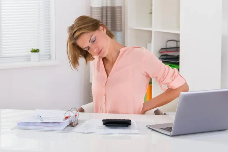 woman at desk with back pain