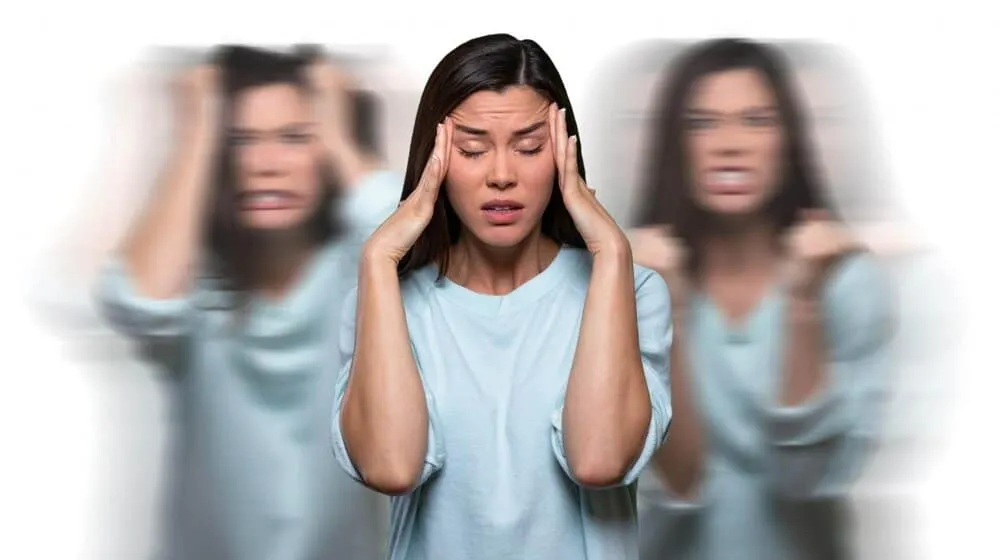womanholdsheadwithmigraine