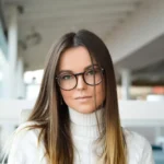 woman smiles wearing glasses