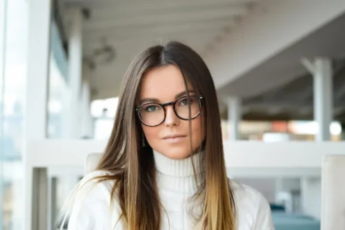 woman smiles wearing glasses