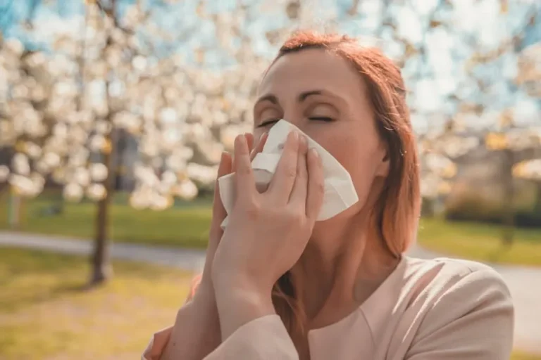 woman sneezes with hay fever