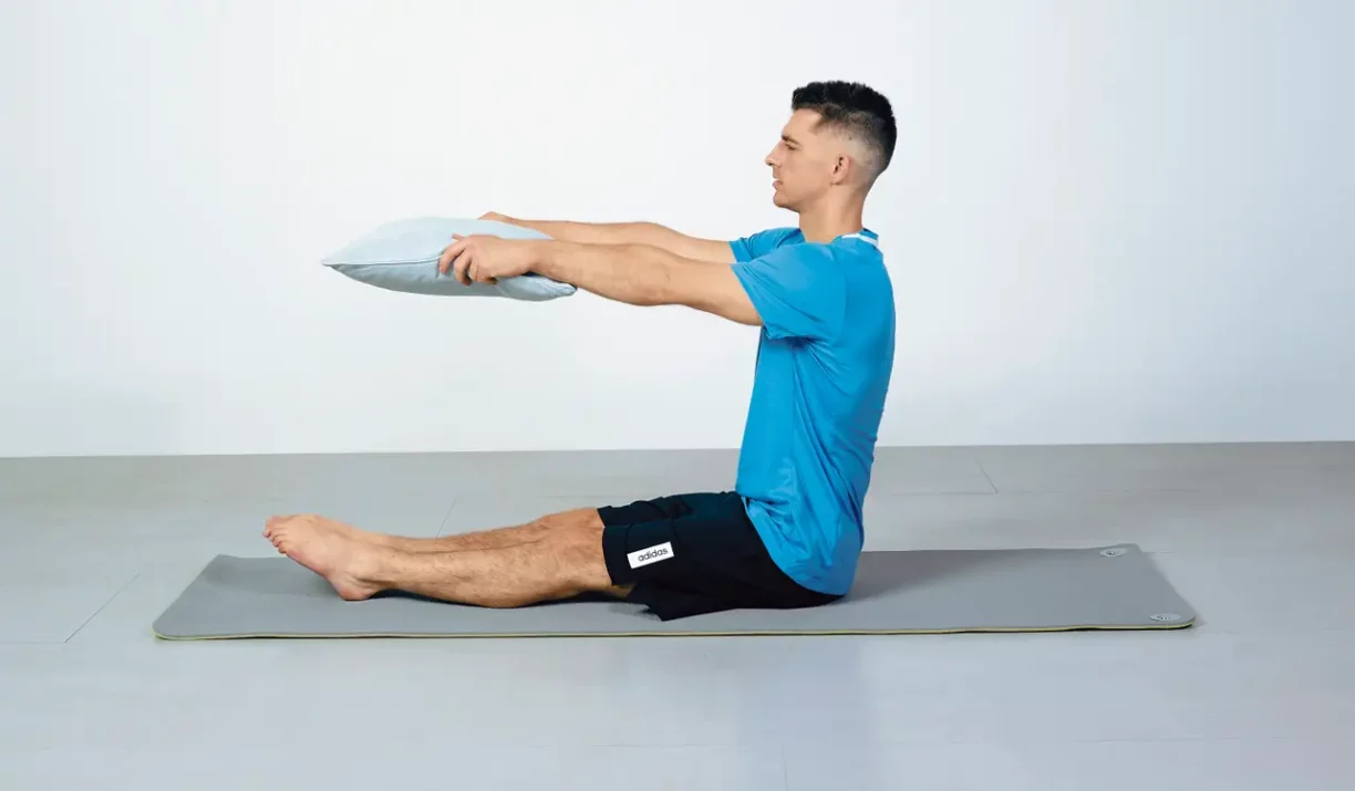 Max Whitlock holds pillow out in front