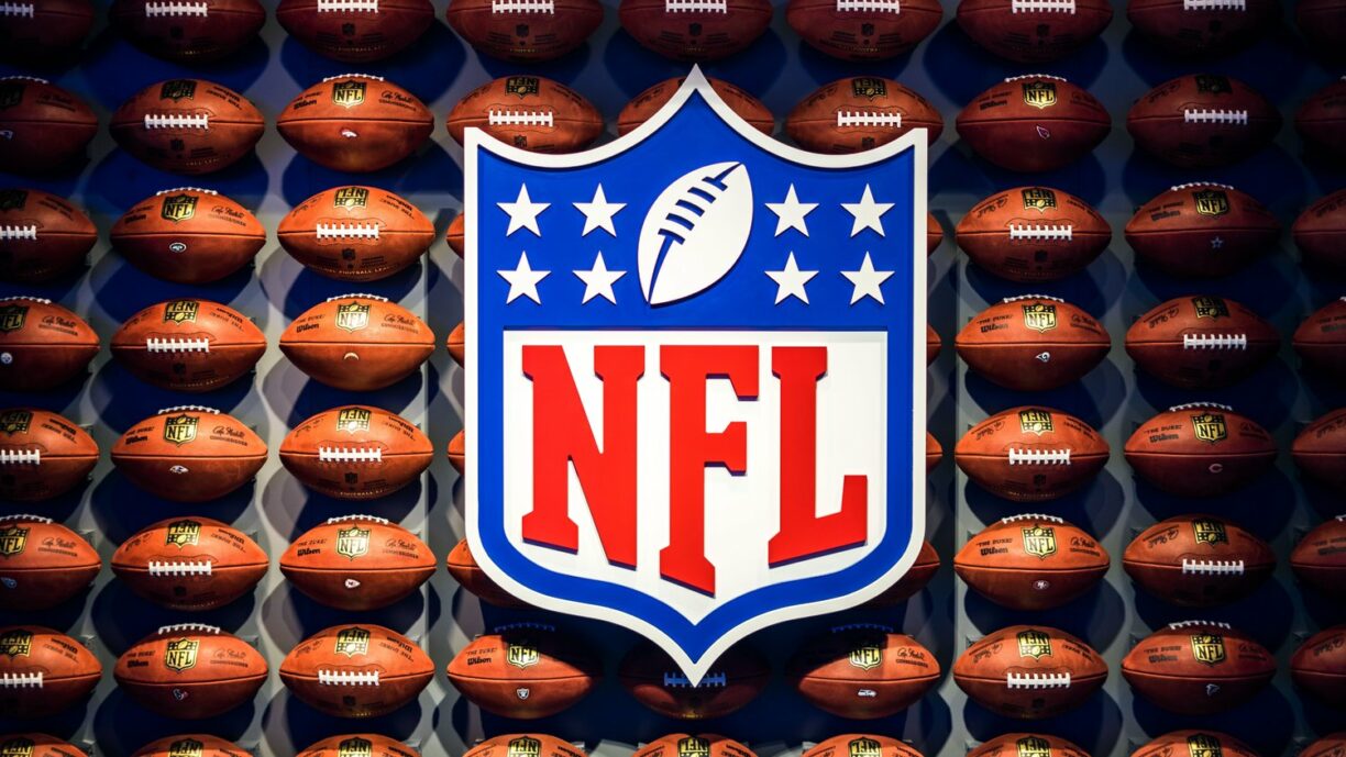 nfl logo with footballs in background