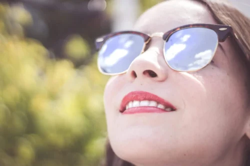 woman wearing blue framed sunglasses scopio d767622c 36c2 44f8 b754 1e3644b51253 scaled