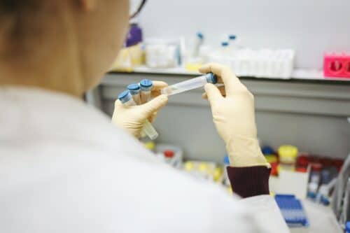 medical professional examines test tube in laboratory