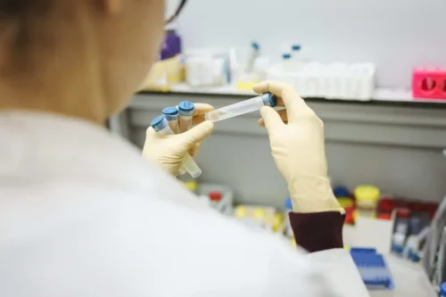 medical professional examines test tube in laboratory