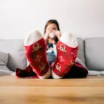 person sitting wearing christmas socks