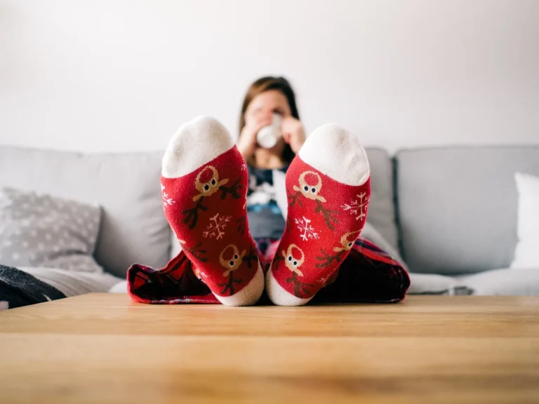 person sitting wearing christmas socks