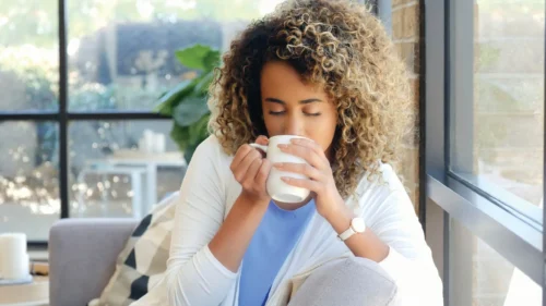 woman drinks from cup scaled