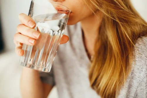 woman drinks from glass