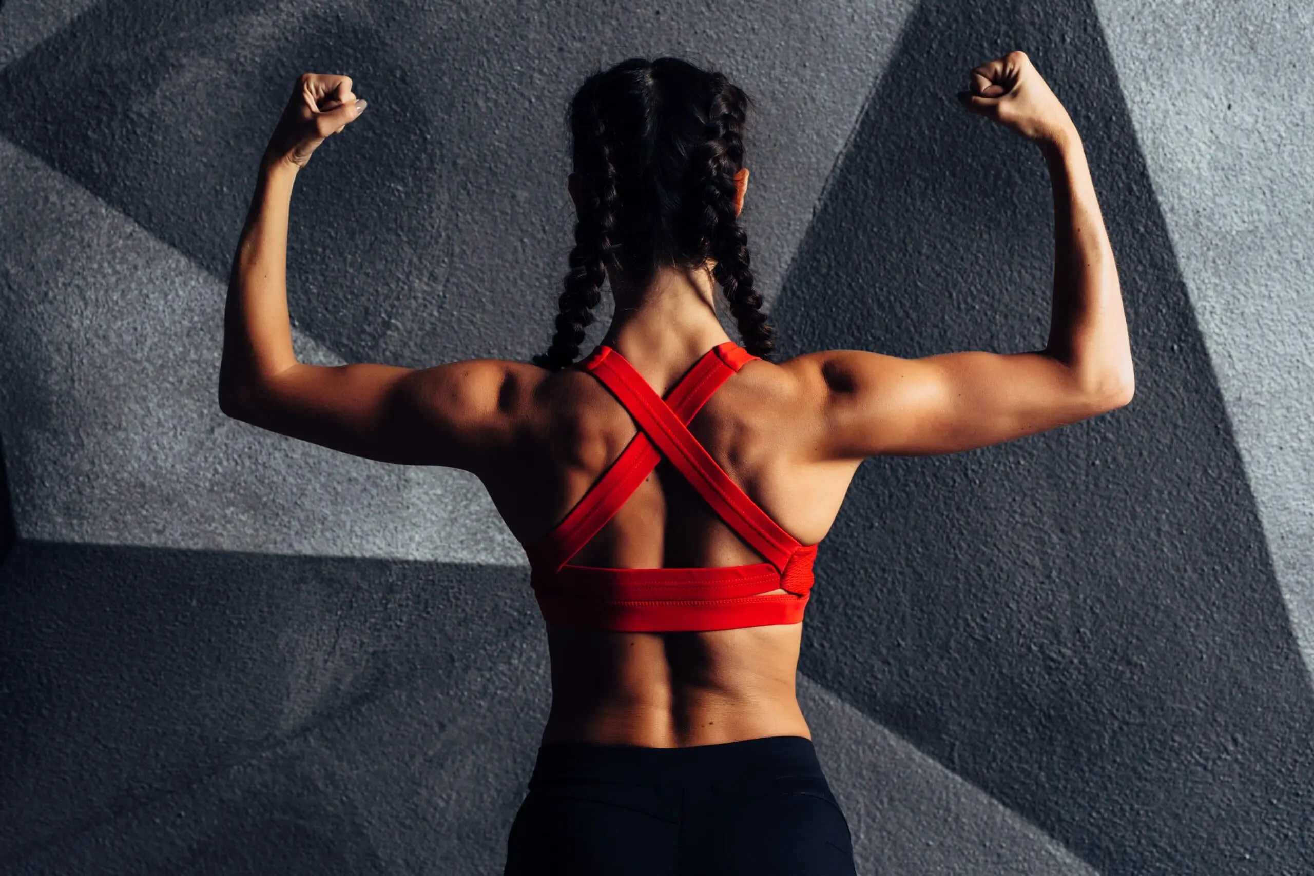Woman flexing back muscle scaled