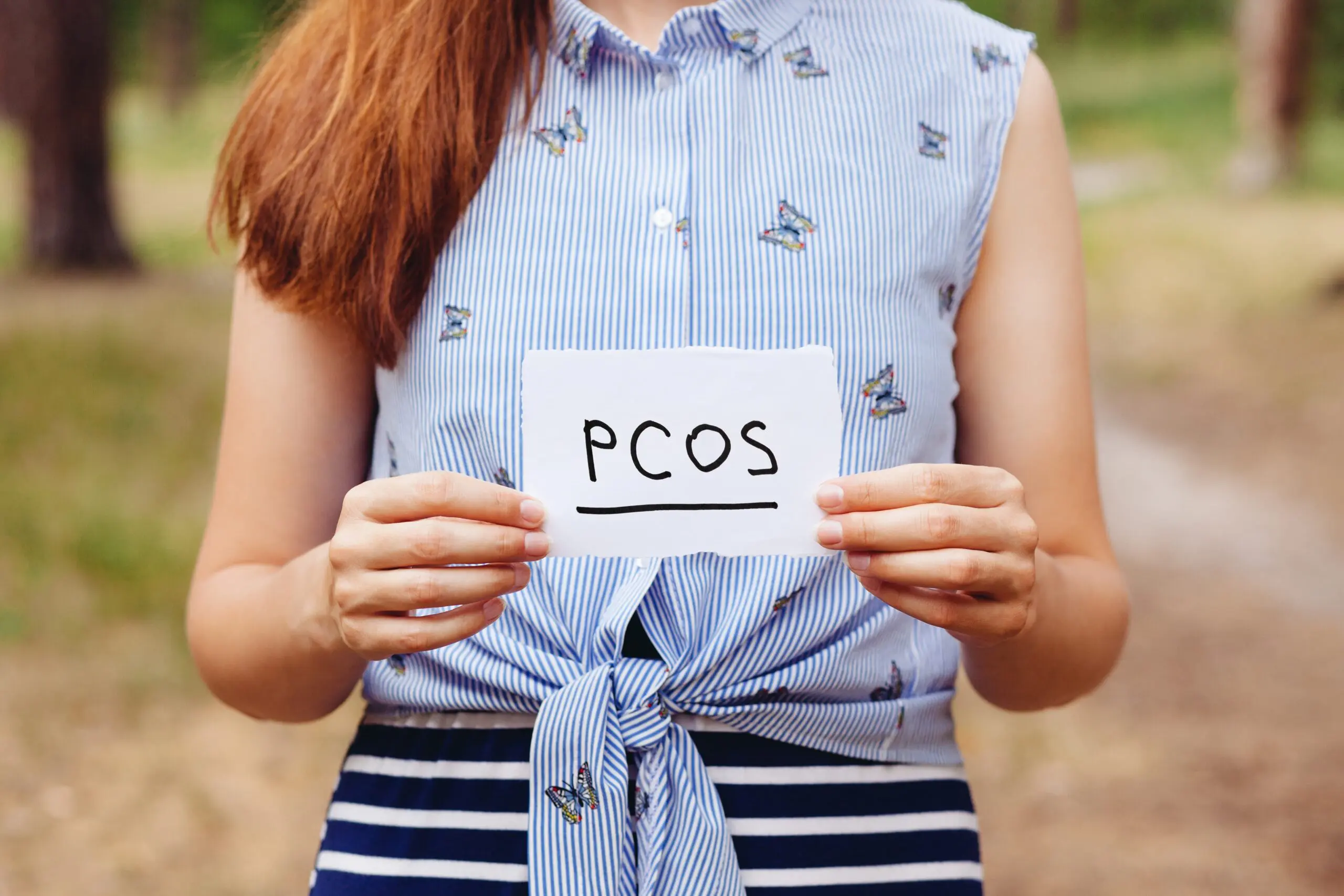 Woman holds pcos sign scaled