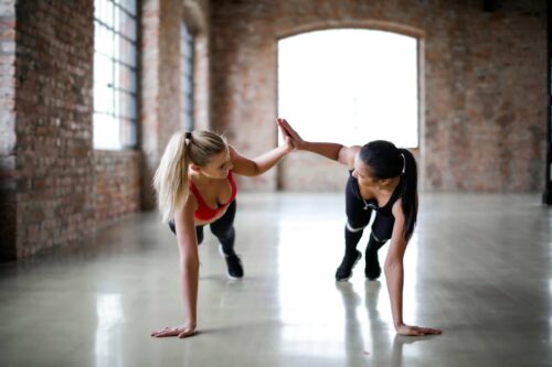 women high five whilst planking scaled