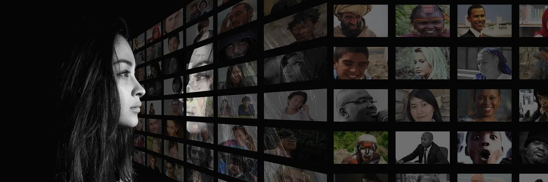 Young girl looking at faces on monitors