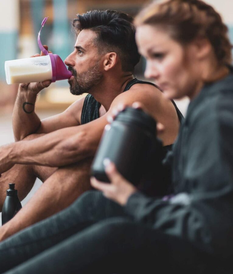 Couple drink protein shakes scaled e1626535916445