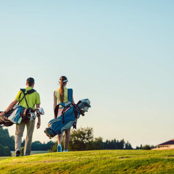 couple walking on golf course