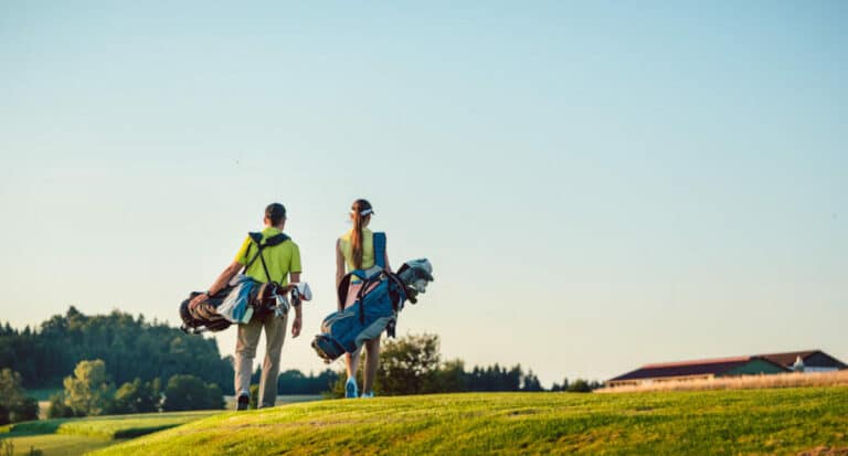 couple walking on golf course