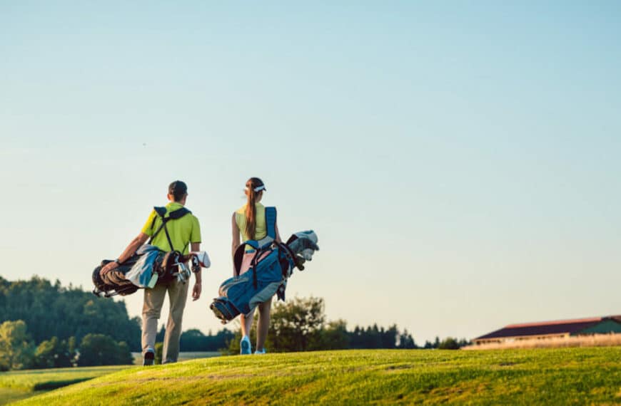 couple walking on golf course