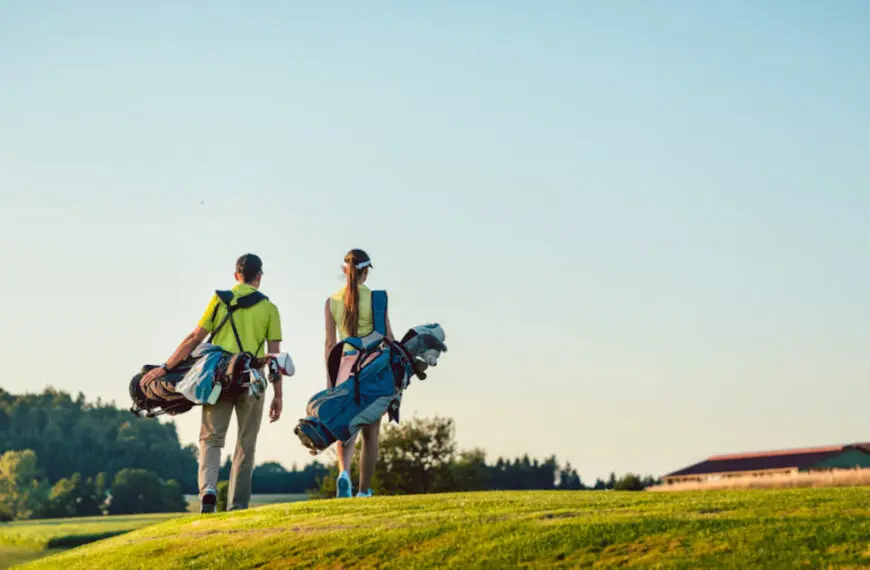 couple walking on golf course 1