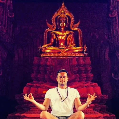 jonny pach meditating in front of budha