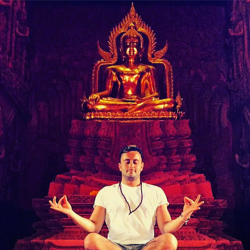 jonny pach meditating in front of budha